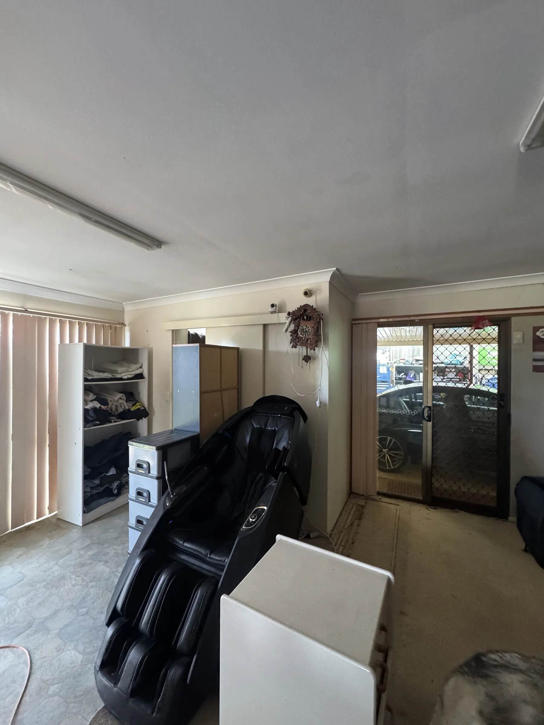 Before: crowded utility area with furniture, appliances, and stored items before the property reorganisation and interior clean-up