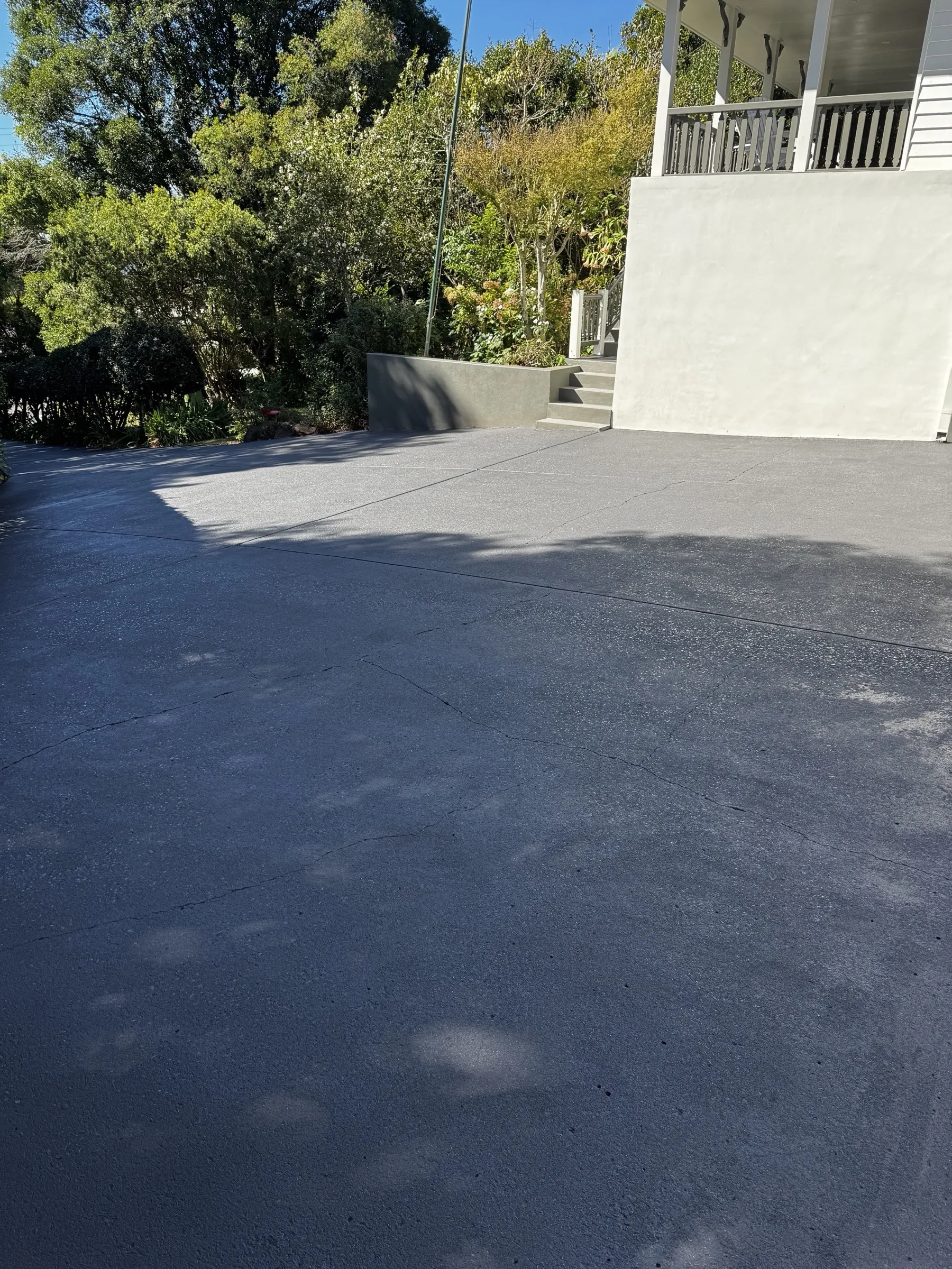 Driveway reseal viewed from road-level showing the depth of the property approach