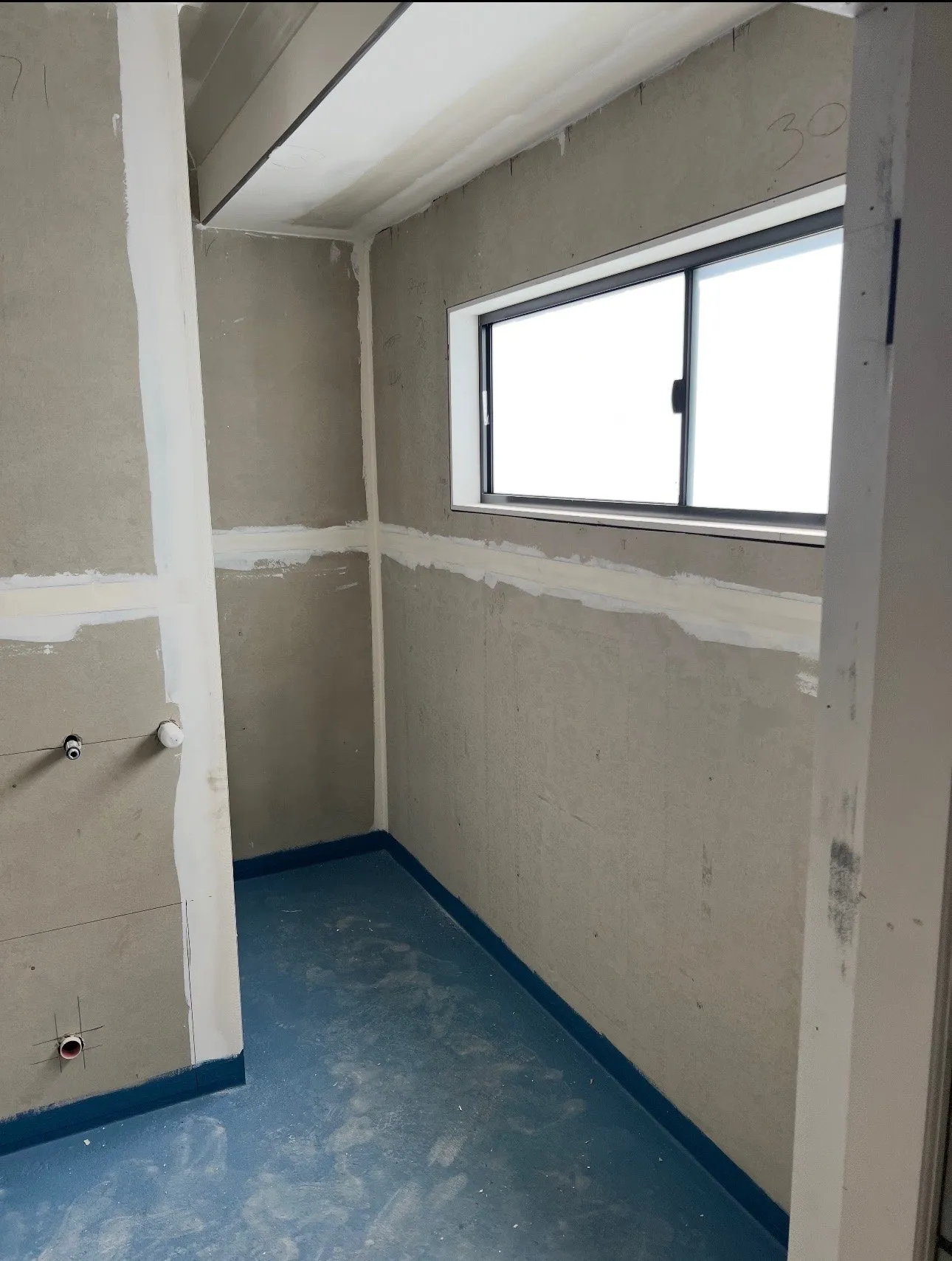 A stripped-back bathroom prepped for a micro cement finish