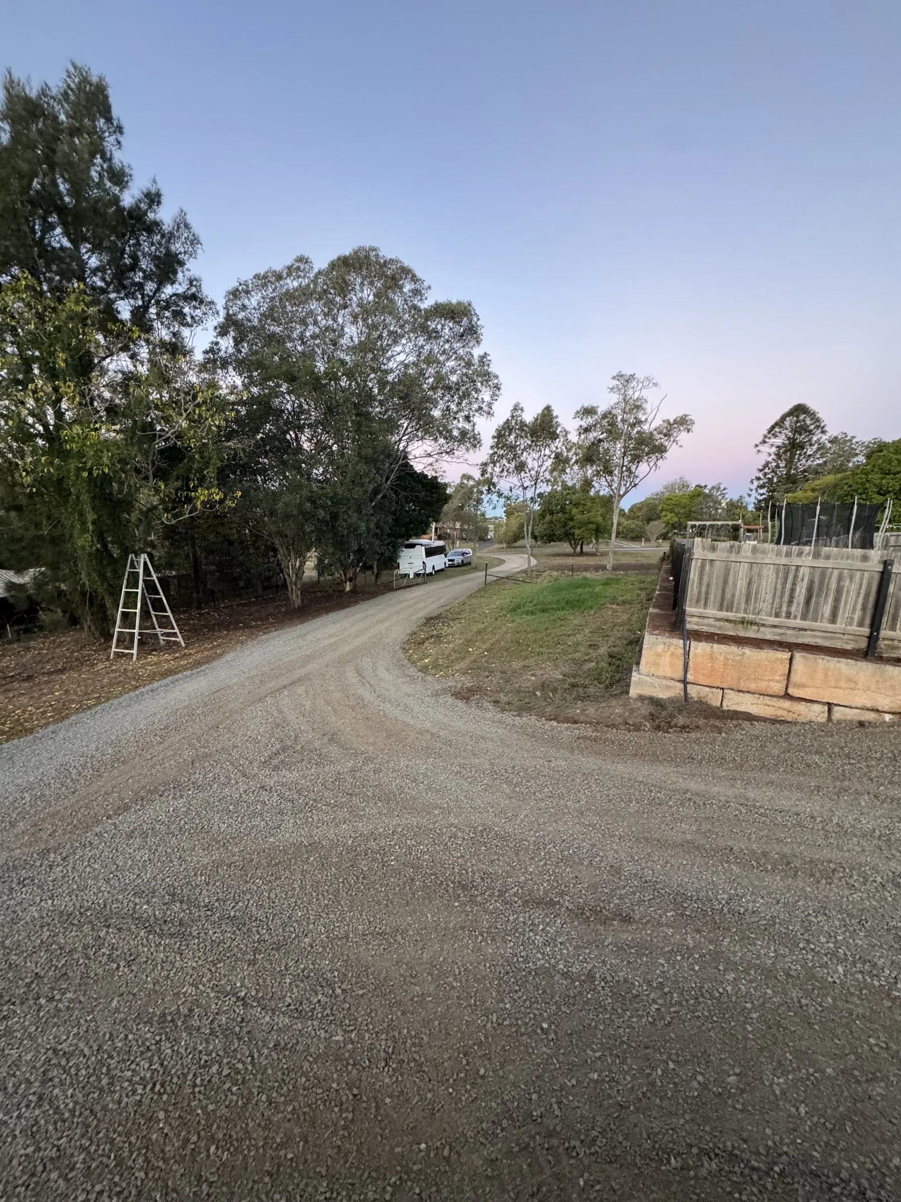 A freshly laid gravel driveway and new timber sleeper retaining wall on a Southern Downs yard transformation